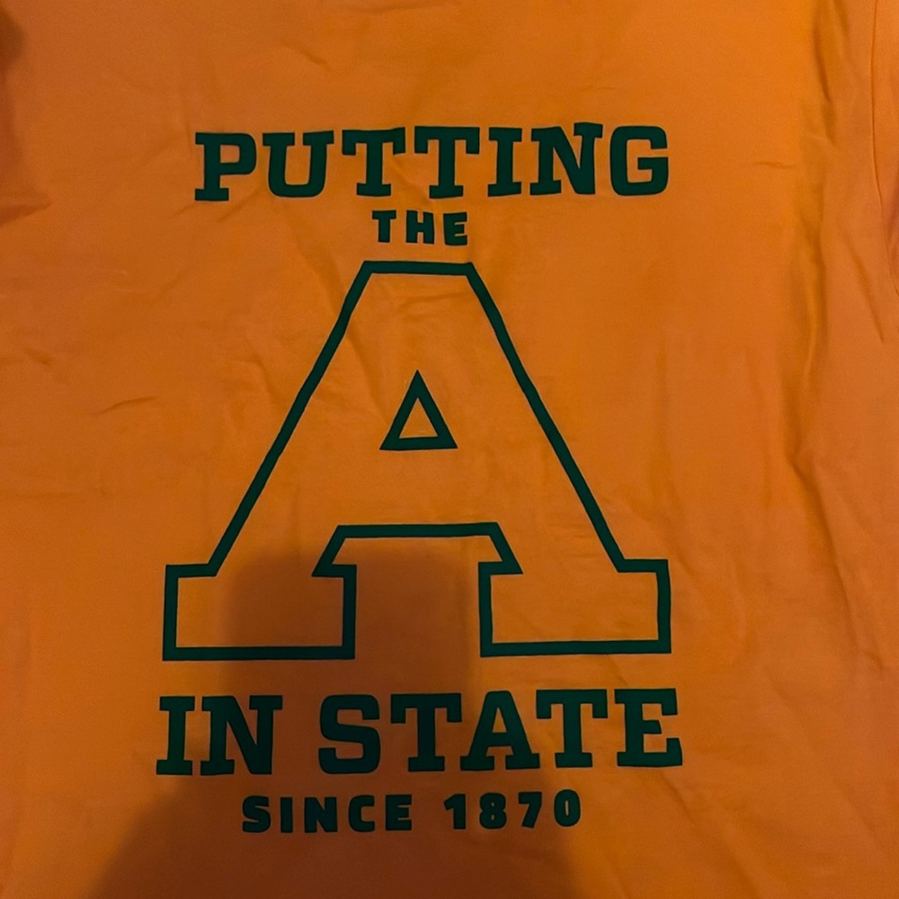 Orange shirt from AG “putting the A in state since 1870”